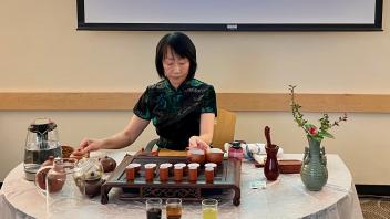 A lecturer demonstrating traditional tea ceremony