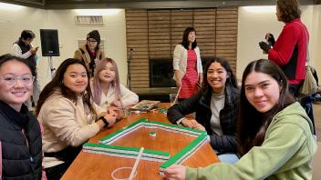 Students at an event playing Mahjong